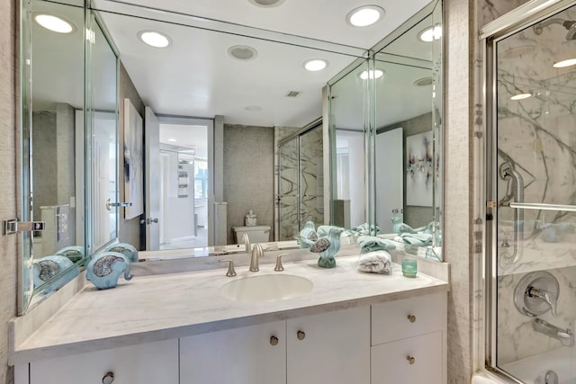 bathroom with an enclosed shower, vanity, and toilet