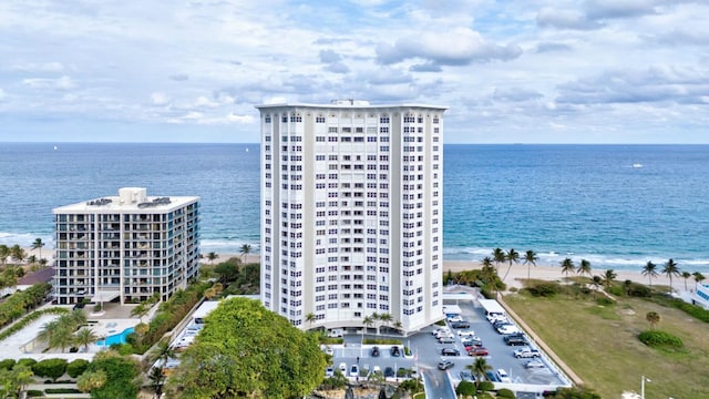 birds eye view of property featuring a water view and a beach view