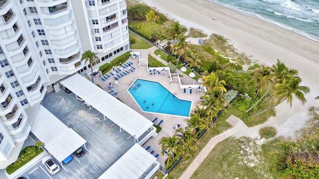 aerial view with a water view and a beach view