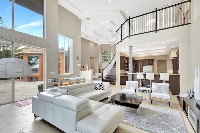 living room with tile patterned floors and a towering ceiling