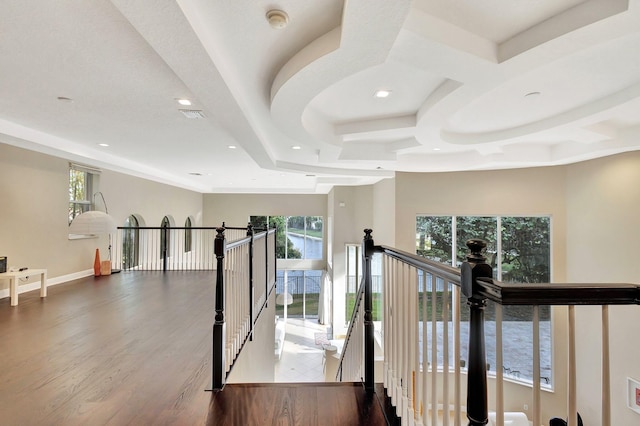 corridor with hardwood / wood-style flooring and coffered ceiling