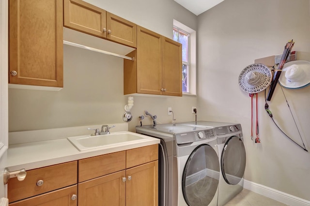 washroom with washer and clothes dryer, light tile patterned flooring, sink, and cabinets