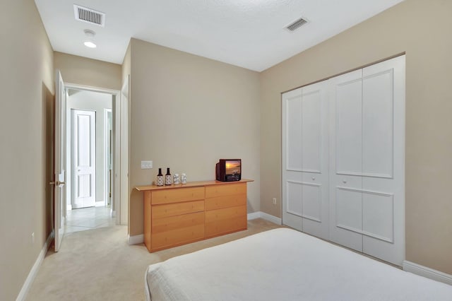 carpeted bedroom featuring a closet