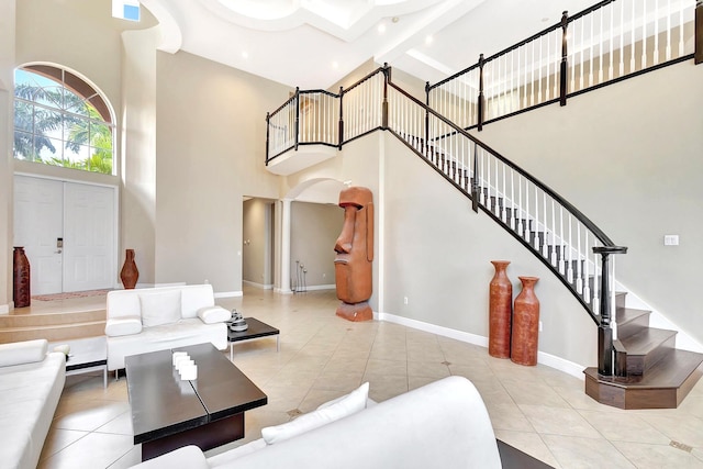 tiled living room with a towering ceiling