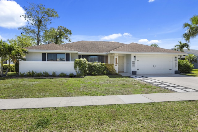 ranch-style home featuring a front yard and a garage