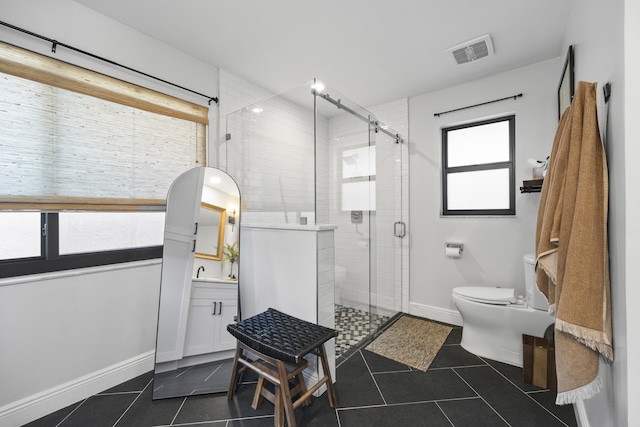 bathroom with vanity, a healthy amount of sunlight, and walk in shower