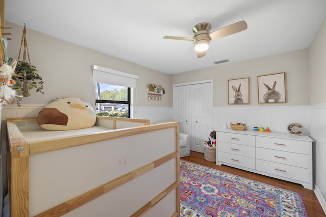 bedroom with ceiling fan, hardwood / wood-style floors, and a closet