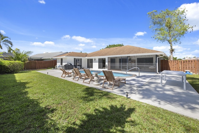 view of swimming pool featuring a lawn and a patio