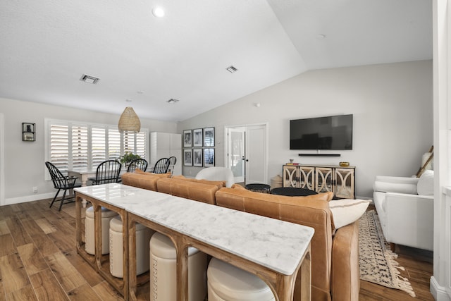 living room with lofted ceiling and hardwood / wood-style floors