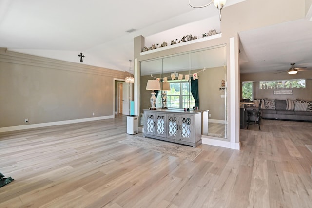 unfurnished living room featuring ceiling fan, light hardwood / wood-style flooring, and vaulted ceiling