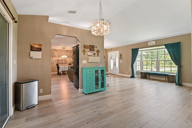 interior space with a notable chandelier and light hardwood / wood-style floors