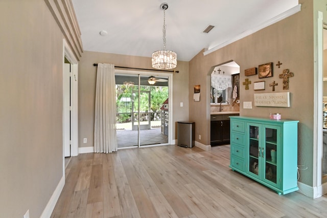 interior space featuring sink, a chandelier, and light wood-type flooring