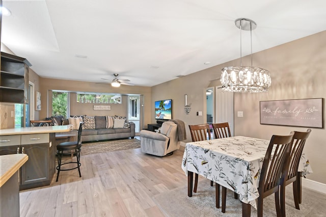 dining space with light hardwood / wood-style floors and ceiling fan