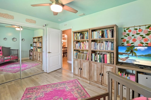 living area with ceiling fan and light hardwood / wood-style flooring