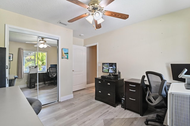 office area with light wood-type flooring and ceiling fan