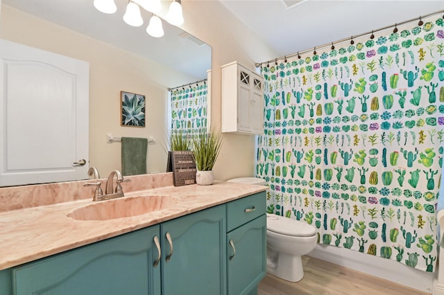 bathroom with hardwood / wood-style flooring, toilet, vanity, and a shower with curtain