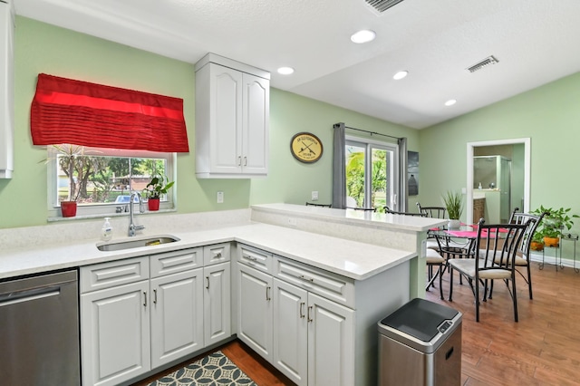 kitchen featuring white cabinetry, dishwasher, kitchen peninsula, and sink