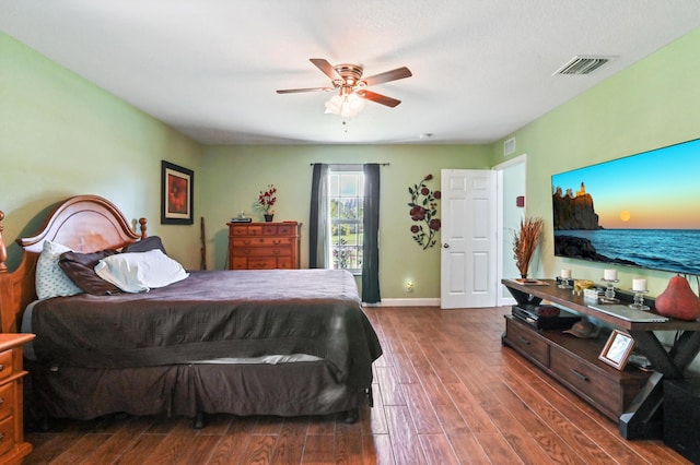 bedroom featuring ceiling fan and dark hardwood / wood-style floors