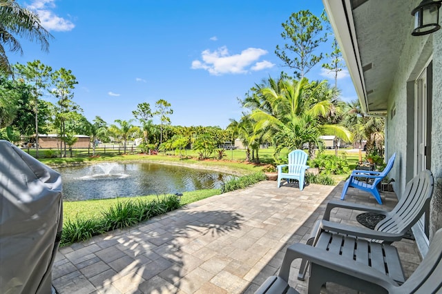 view of patio / terrace featuring a water view and area for grilling