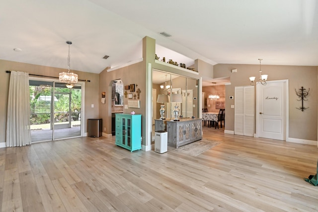 kitchen featuring vaulted ceiling, decorative light fixtures, light hardwood / wood-style flooring, and a notable chandelier