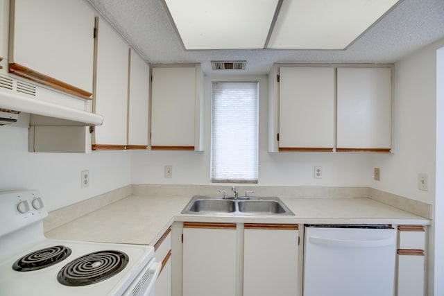 kitchen featuring white appliances, white cabinetry, and sink