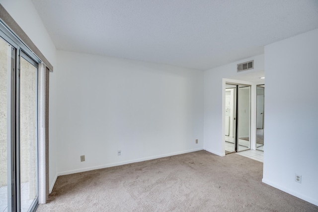 unfurnished bedroom with light colored carpet