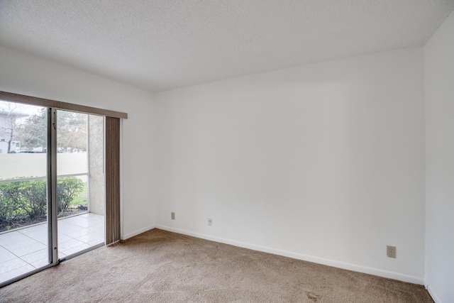 carpeted empty room with a textured ceiling