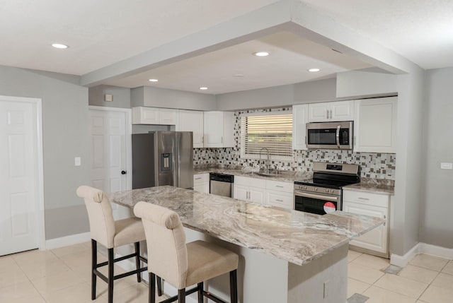 kitchen featuring white cabinets, appliances with stainless steel finishes, and a kitchen island