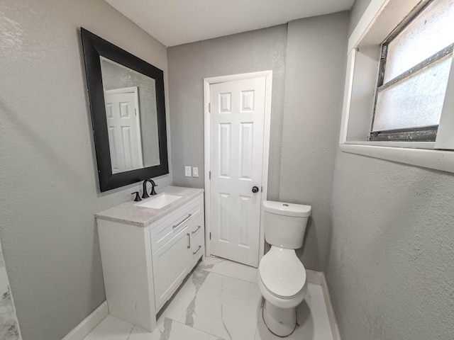 bathroom featuring toilet and vanity