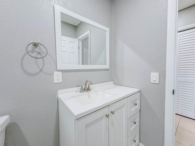 bathroom with tile patterned floors and vanity