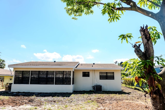 rear view of property with cooling unit