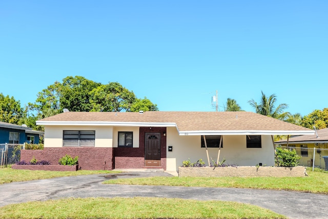 ranch-style home featuring a front lawn