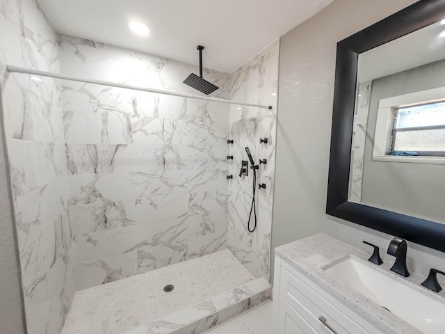 bathroom featuring vanity and tiled shower