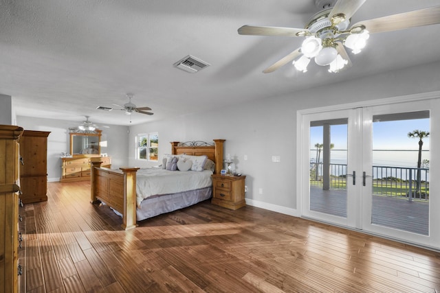 bedroom featuring ceiling fan, access to exterior, wood-type flooring, and french doors