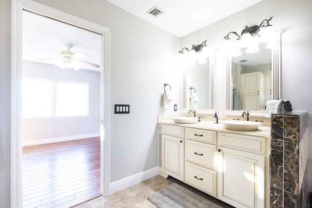 bathroom with ceiling fan and vanity