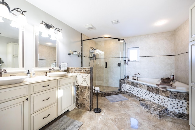 bathroom featuring vanity and shower with separate bathtub