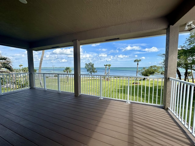 wooden deck featuring a water view and a yard