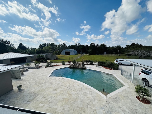 view of swimming pool featuring a patio area and a lawn