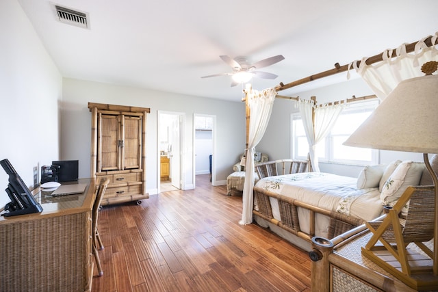 bedroom with ceiling fan, hardwood / wood-style floors, and ensuite bathroom