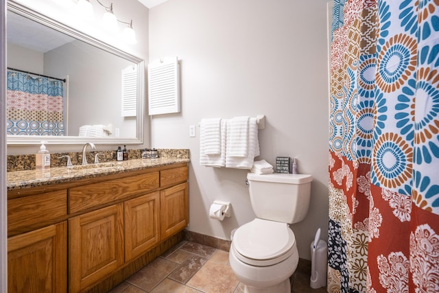 bathroom with toilet, vanity, and walk in shower