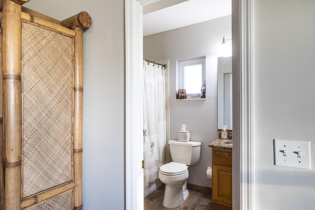 bathroom featuring curtained shower, tile patterned floors, toilet, and vanity