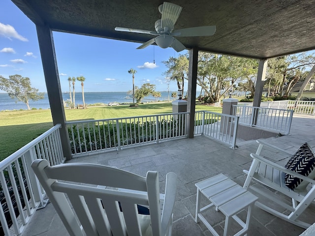 view of patio / terrace with a water view and ceiling fan