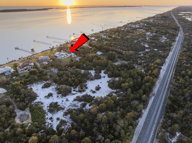 aerial view at dusk with a water view