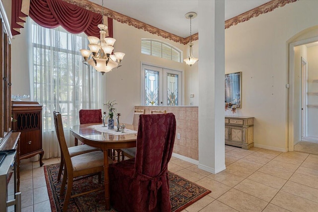 tiled dining space with french doors and an inviting chandelier