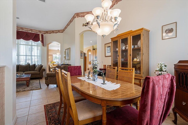 dining space with a chandelier and light tile patterned flooring