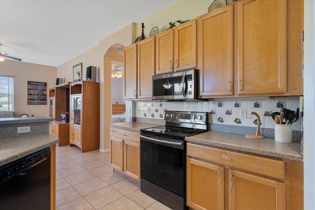 kitchen featuring ceiling fan, black appliances, tasteful backsplash, and light tile patterned flooring