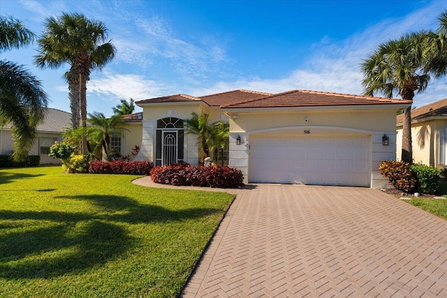 mediterranean / spanish-style house with a front yard and a garage