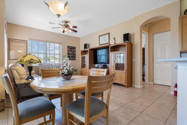 tiled dining room with ceiling fan