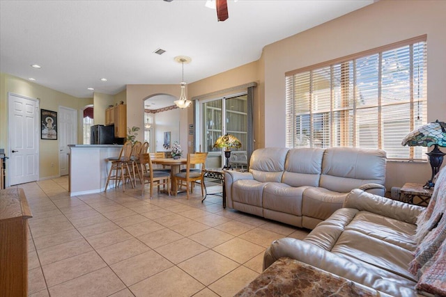 tiled living room featuring ceiling fan