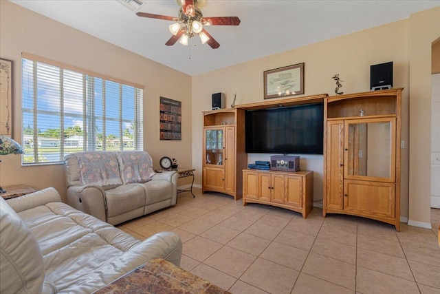 tiled living room with ceiling fan